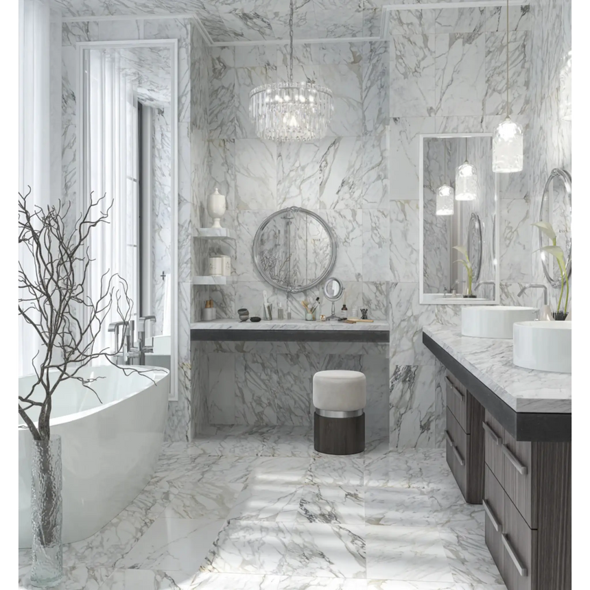 Modern bathroom with marble walls and floor, featuring a freestanding bathtub and double vanity.