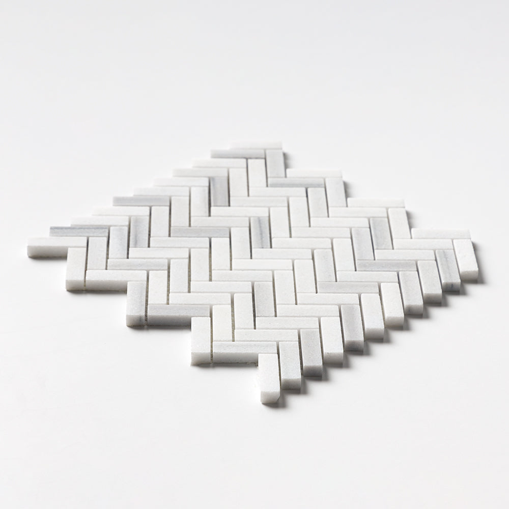Close-up of Carrara Neptune Honed Herringbone Marble Mosaic showing fine Italian marble texture.