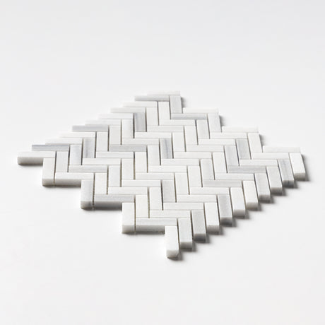 Close-up of Carrara Neptune Honed Herringbone Marble Mosaic showing fine Italian marble texture.
