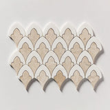 A sheet of scalloped mosaic tiles with alternating beige stone and white pieces outlined in dark brown, arranged in a fan pattern on a light gray background.