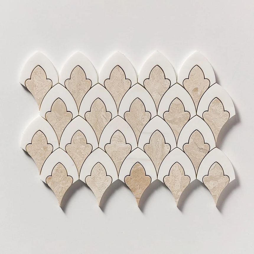 A sheet of scalloped mosaic tiles with alternating beige stone and white pieces outlined in dark brown, arranged in a fan pattern on a light gray background.