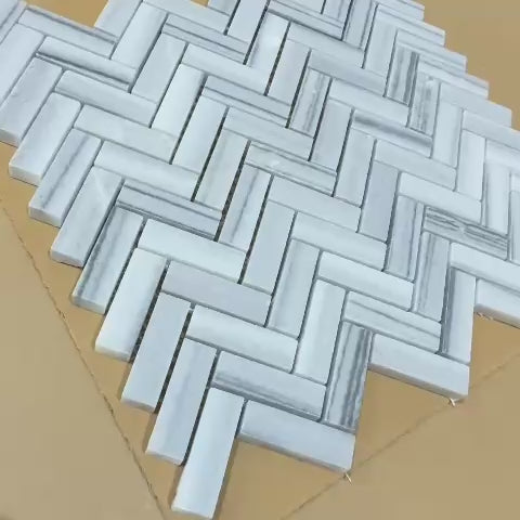 Elegant Italian Carrara Neptune Honed Herringbone Marble Mosaic 15×50 mm tiles. Soft matte finish, 6 sheets per box, luxury marble for bathrooms & kitchens.
